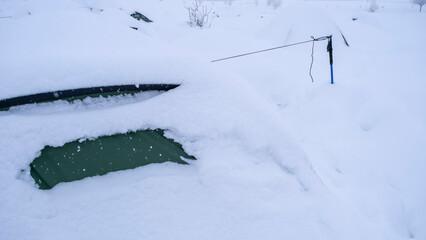 Mountaineering tents with parts visible after heavy snowfall and blizzard