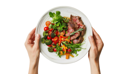 Chef holding plate with sliced beef and roasted vegetables on transparent background