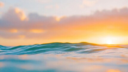 Fototapeta premium Soft waves caress the shore as the sun sets on the horizon, painting the sky with warm hues of orange and pink during twilight