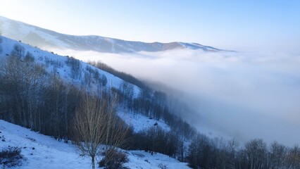 Foggy and cloudy mountain landscape in winter