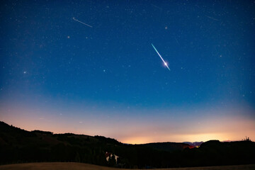Milky Way stars with meteor shower trails.