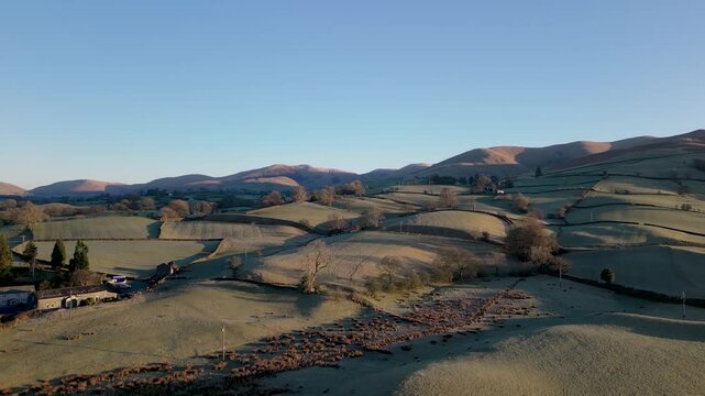 Stunning Drone footage of sunrise in the Yorkshire Dales above the village of Sedbergh. Dawn sunrise above the hills and misty landscape of the Yorkshire dales national Park.