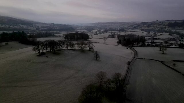 Stunning Drone footage of foggy landscape in the Yorkshire Dales above the village of Sedbergh. Dawn sunrise above the hills and misty landscape of the Yorkshire dales national Park.