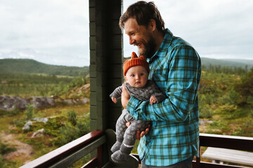 Family lifestyle father with infant baby on terrace playing together, parent with child happy candid emotions bonding together happy dad and kid, Fathers day holiday