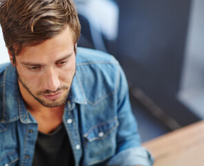 Fototapeta premium Coffee shop, table and man with depression, mental health burnout and top view for financial crisis. Upset, anxiety and person in restaurant for disappointment, stress and thinking on mistake or fail