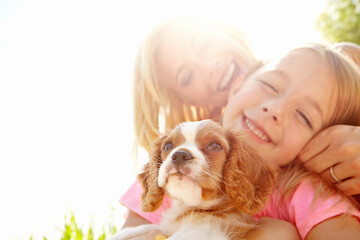 Outdoor, woman and child with dog after adoption, puppy care and bonding together with happiness. Flare, mother and girl with Cavalier pet for companion, animal and connection with mockup in nature