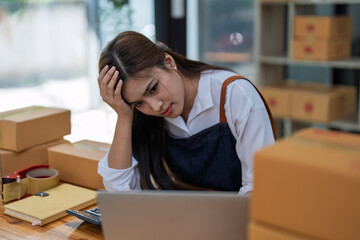 Young woman engaged in online business with stress thoughtful within data products Sales did not meet target Selling products of This month