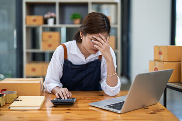 Young woman engaged in online business with stress thoughtful within data products Sales did not meet target Selling products of This month