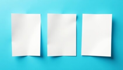 Close up of three empty white paper sheets isolated on blue backdrop, business, template