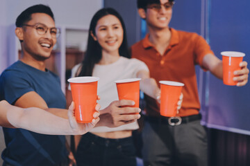 Happy young friends group having lunch at home. Asia family party eating pizza food and laughing enjoying meal while sitting at dining table together at house. Celebration holiday and togetherness.