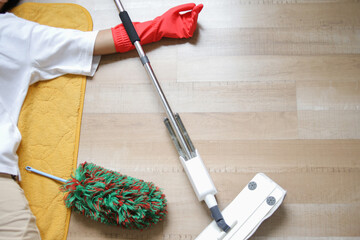 Cropped Shot Of Man Laying On The Floor With Messy Cleaning Tools