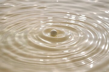  Photograph of a fluid texture with wavy patterns in various shades of cream and white, showing depth
