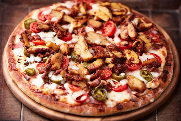 Gyros Pizza with jalapeno pepper, cherry tomatoes and mozzarella cheese. Soft focus. Close up.