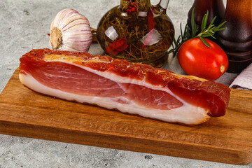 Piece prosciutto crudo over board