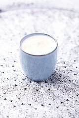 Cappuccino on bright background. Soft focus. Copy space.