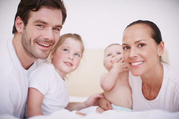 Bedroom, children and parents with smile in portrait, connection and growth development for baby. Father, mother and girl with newborn infant for childhood, bonding and relationship as family at home
