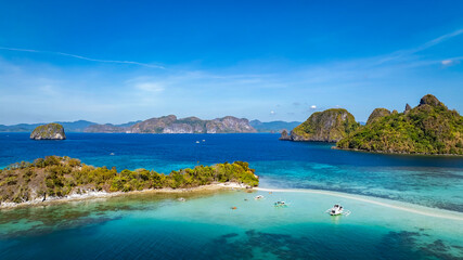 Fototapeta premium Aerail view of tropical exotic island sand bar separating sea in two with turquoise in El Nido, Palawan, Philippines.