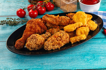 Golden crispy fried chicken mix - wings, drumsticks, nuggets and strips
