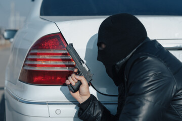 Criminal Preparing to Attack Car with Pistol