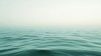 Fototapeta premium Calm ocean surface with subtle waves under a hazy sky.