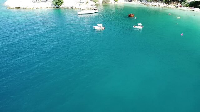 Aerial video over boats and coastline on Potos Island Greece