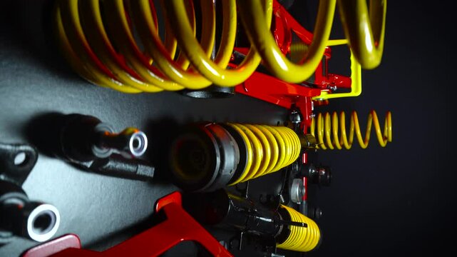 tuned new parts spare parts for the front suspension of a front-wheel drive car ball silent blocks coilovers yellow and a jack with stands