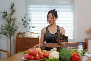 Young asian woman preparing healthy meal with fresh vegetables