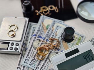 Items collected for appraisal include cash, jewelry, and weighing scales at a financial service