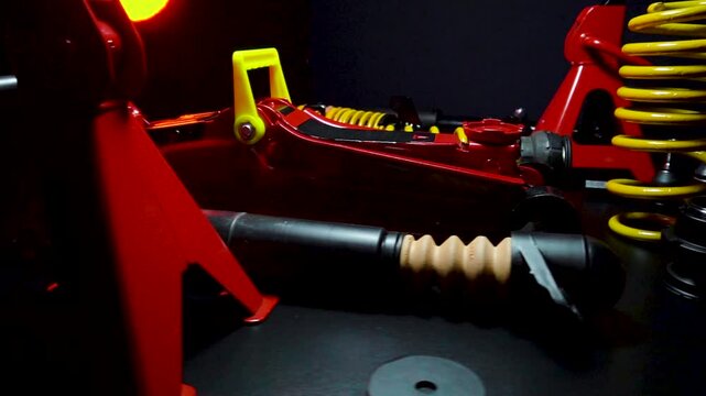 tuned new parts spare parts for the front suspension of a front-wheel drive car ball silent blocks coilovers yellow and a jack with stands