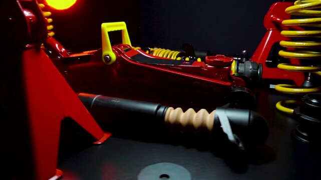 tuned new parts spare parts for the front suspension of a front-wheel drive car ball silent blocks coilovers yellow and a jack with stands