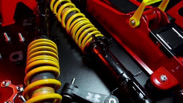 tuned new parts spare parts for the front suspension of a front-wheel drive car ball silent blocks coilovers yellow and a jack with stands