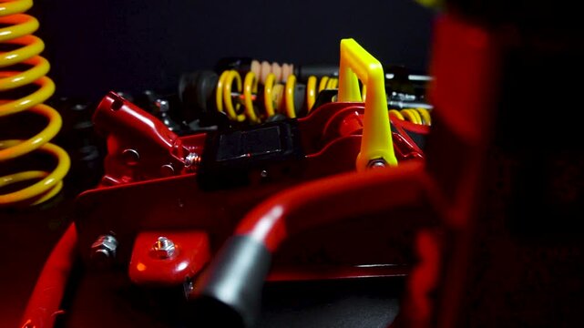 tuned new parts spare parts for the front suspension of a front-wheel drive car ball silent blocks coilovers yellow and a jack with stands