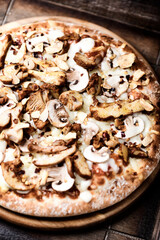 Gyros Pizza with with champignons and mozzarella cheese. Wooden background. Soft focus