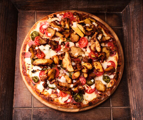 Gyros Pizza with jalapeno pepper, cherry tomatoes and mozzarella cheese. Soft focus.