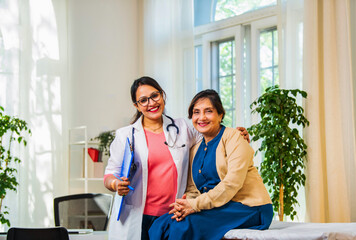 Indian doctor and elderly patient share a warm handshake, celebrating healthcare and recovery