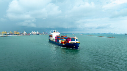 Aerial front view shipping container carrier container depart from commercial port in the rainy...