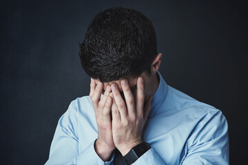 Fototapeta premium Stress, studio and man with frustration, anxiety and thinking of financial crisis, debt and overwhelmed. Contemplating, grey background and person with depression for tax fraud and account manager