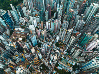 Aerial panorama showcases Hong Kong city's dense urban sprawl. Tall buildings dominate the...