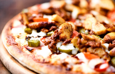 Gyros Pizza with jalapeno pepper, cherry tomatoes and mozzarella cheese. Soft focus.
