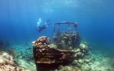 A diver exploring a small sunken ship off the coast of Curacao Island