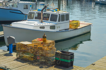Fishing boats and lobster traps at the dock in the harbor of Gloucester, a small fishing village in...
