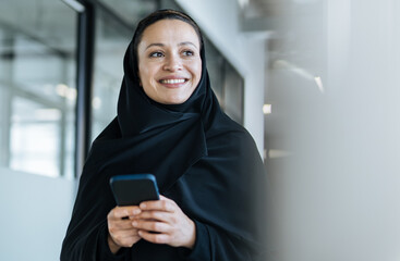 beautiful arabian woman with abaya dress working in the office
