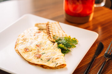 Omelette for breakfast with champignons and sauce.