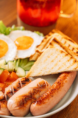 A hearty breakfast of fried eggs, sausages and toast.
