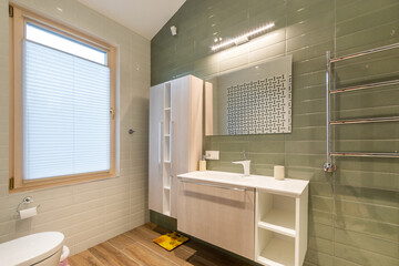 Elegant design of the bathroom, decorated in pastel colors. Stylish furniture, window with blinds.