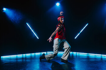 Fototapeta premium Hip hop dancer dancing in a cool studio with neon lights.