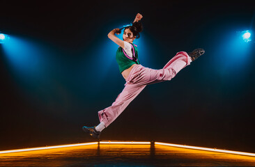 Hip hop dancer dancing in a cool studio with neon lights.