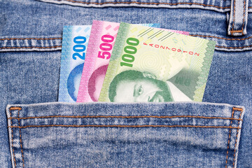 Mozambican metical  in the pocket of blue jeans