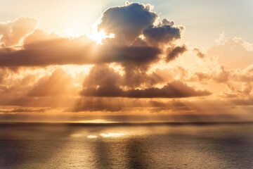 cloud in a form of flying sauser with light and shadows in amazing sunrise or sunset sky above water in beautisul seascape