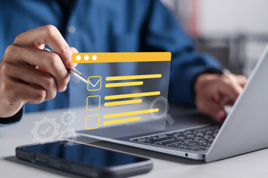 Survey form concept. Businessman using laptop with questionnaire with checkboxes on virtual screen, Filling survey form online and answer questions of test.